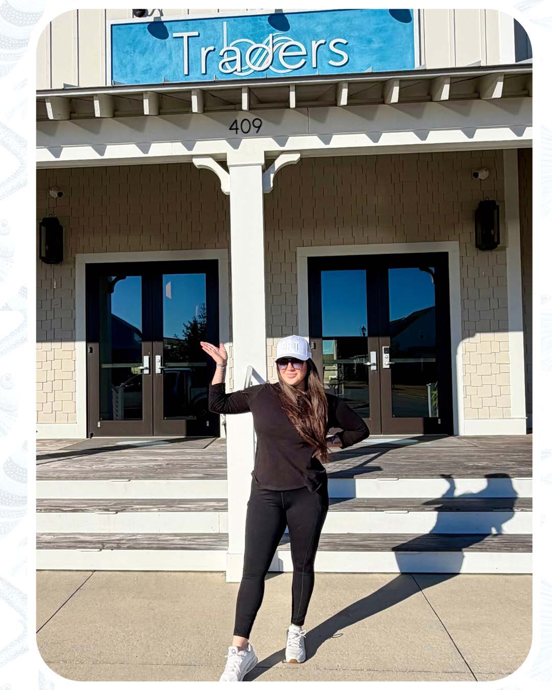 a person standing in front of a business on a sunny day